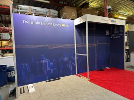 RENTAL: Custom Inline Design with 234" Wide x 118.75" High Gravitee Backwall, S44 Extrusion Return Frame Supporting Ceiling and Header Structure, (4) Monitor Mounts,(5) LED Arm Lights, 75" Monitor, (2) 43" Monitors, SEG Fabric Graphics, and Direct Print S