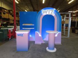 Custom Symphony Portable SYK-1038 Display with Fabric and Direct Print Graphics, Shelves, Rainbox Aero Tube Frame, Monitor Mount, Square Reception Counter, and Small Bistro Table