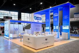 RENTAL: Custom Island Rental Design with Gravitee Storage Tower @ 96" W x 42" D x 190" H, (1) Double-Sided Lightbox @ 9' W x 9' H, (3) Double-Sided Lightbox Kiosks @ 42" W x 190" H, (6) RE-1594 Workstation Counters with Recessed RGB Accent Lighting, (2) S